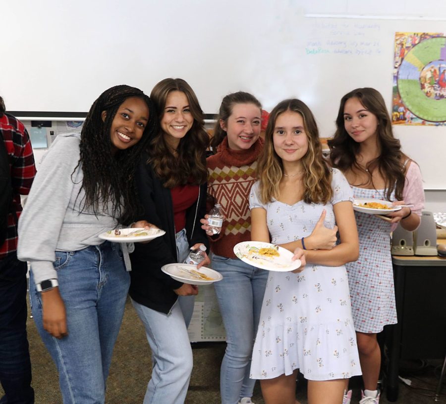 A group of students enjoying the potluck.